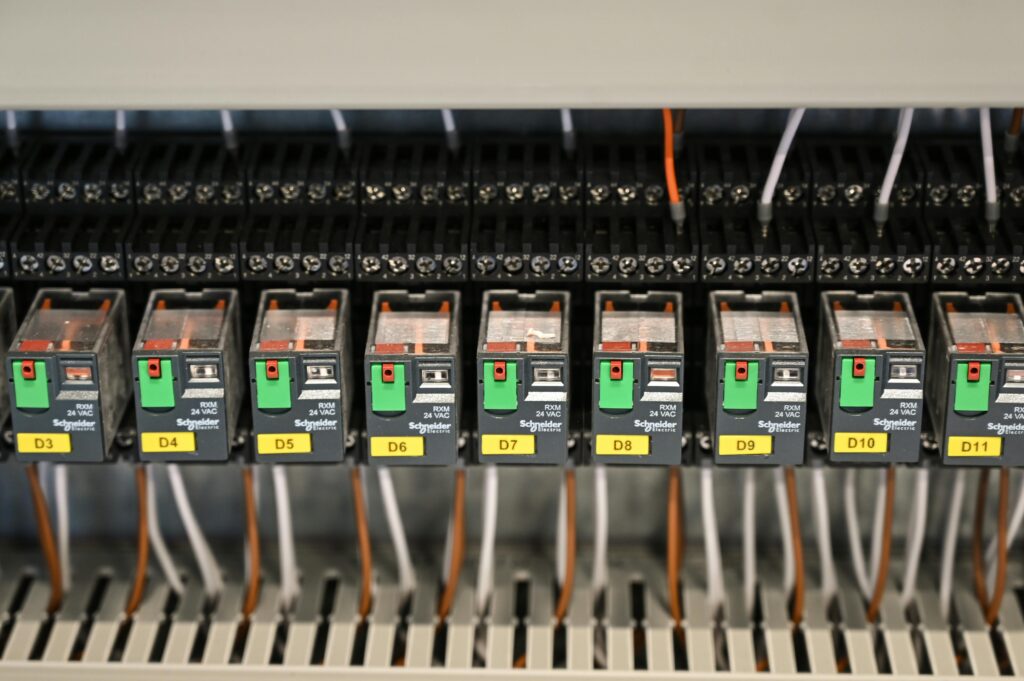 Close-up view of electrical relays in an industrial panel box showcasing circuit components.